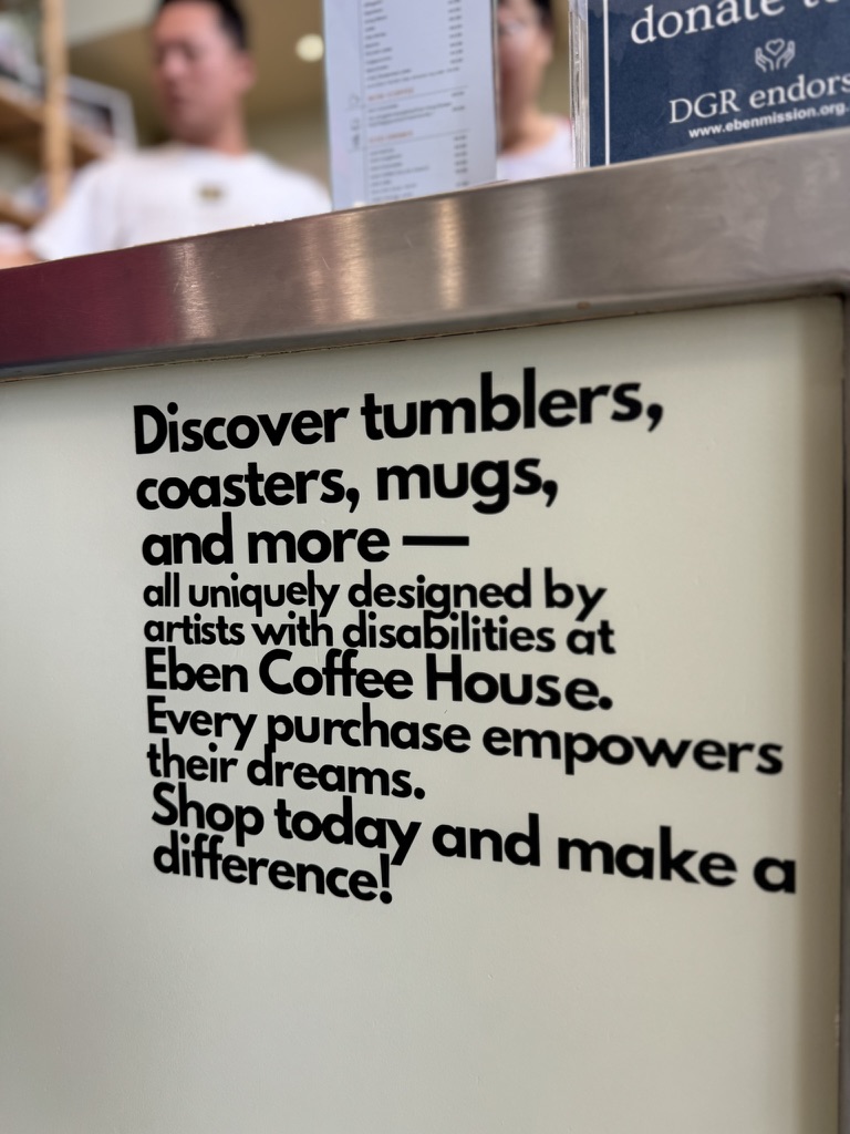 A sign at Eben Coffee House explaining how purchases of artist-designed products support artists with disability