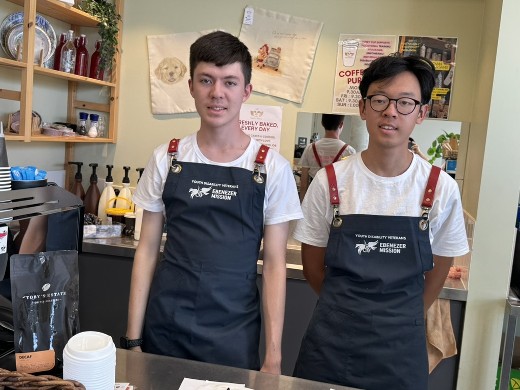 Two young baristas working at Eben Coffee House